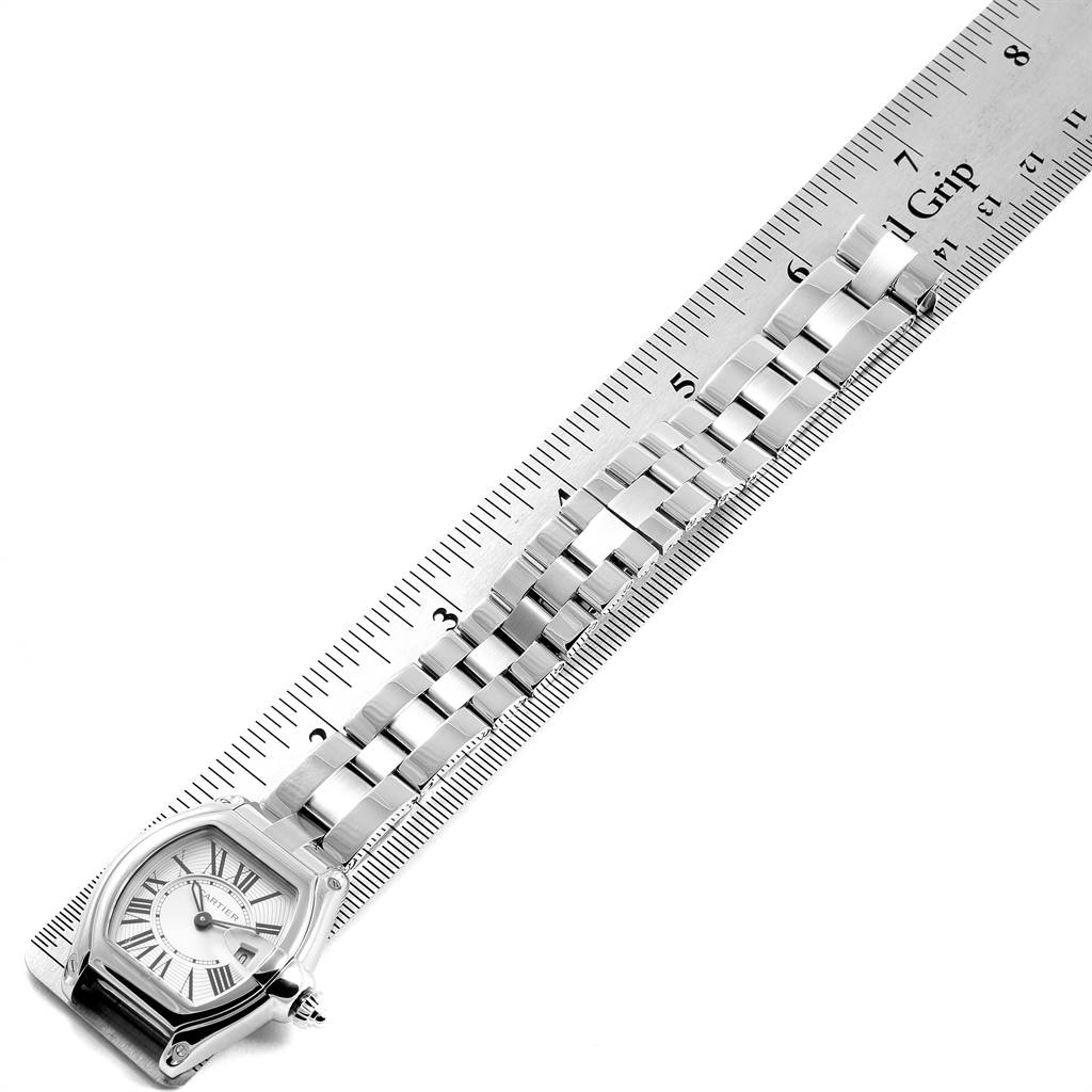 This image shows a Cartier Roadster W62016V3 Women
s Stainless Steel Silver Dial W62016V3 Women
s Stainless Steel Silver Dial watch from an overhead angle, displaying the face and bracelet along a ruler.