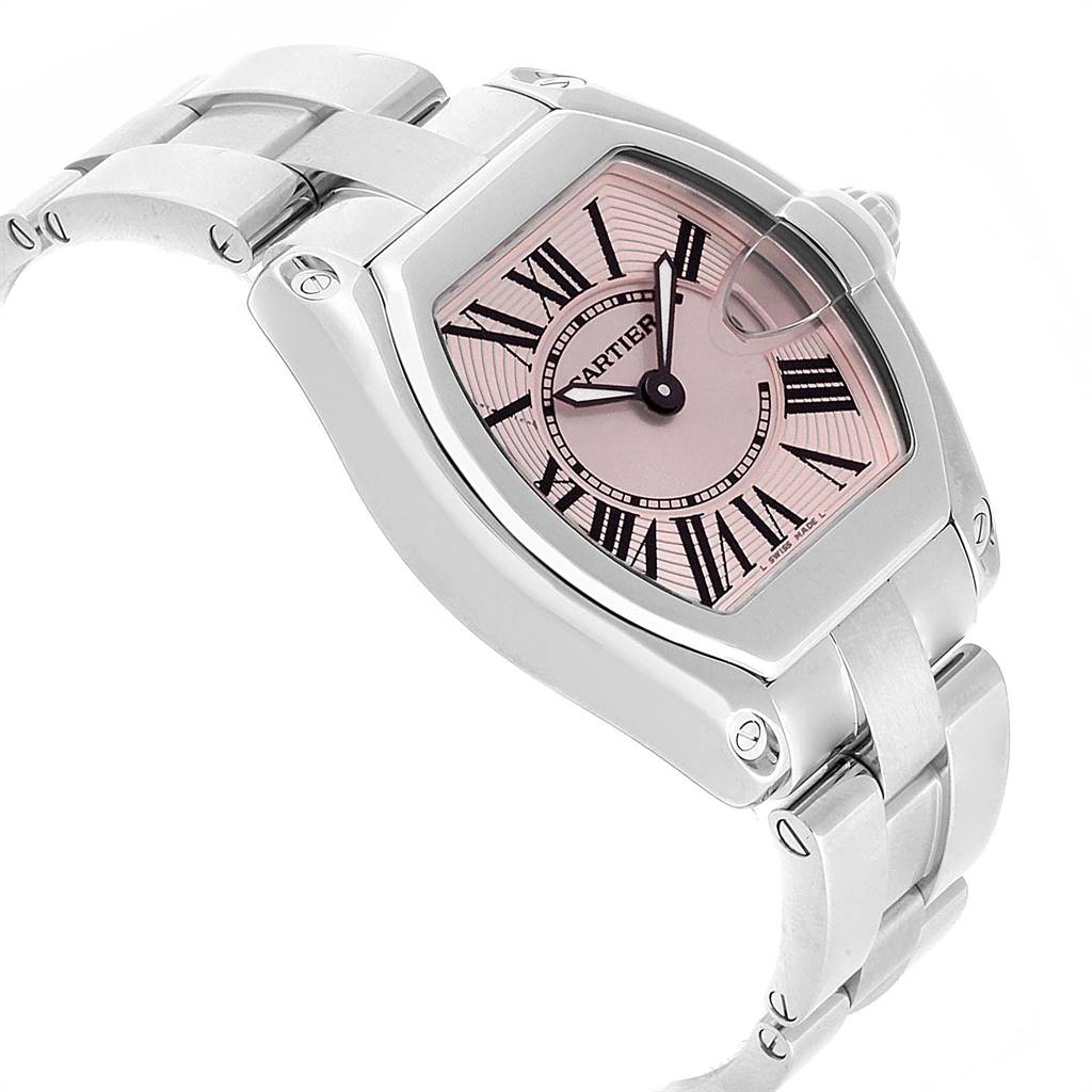 The image shows a Cartier Roadster W62017V3 Women
s Stainless Steel Pink Dial W62017V3 Women
s Stainless Steel Pink Dial watch with a pink dial face and silver band, viewed from an angled side perspective.