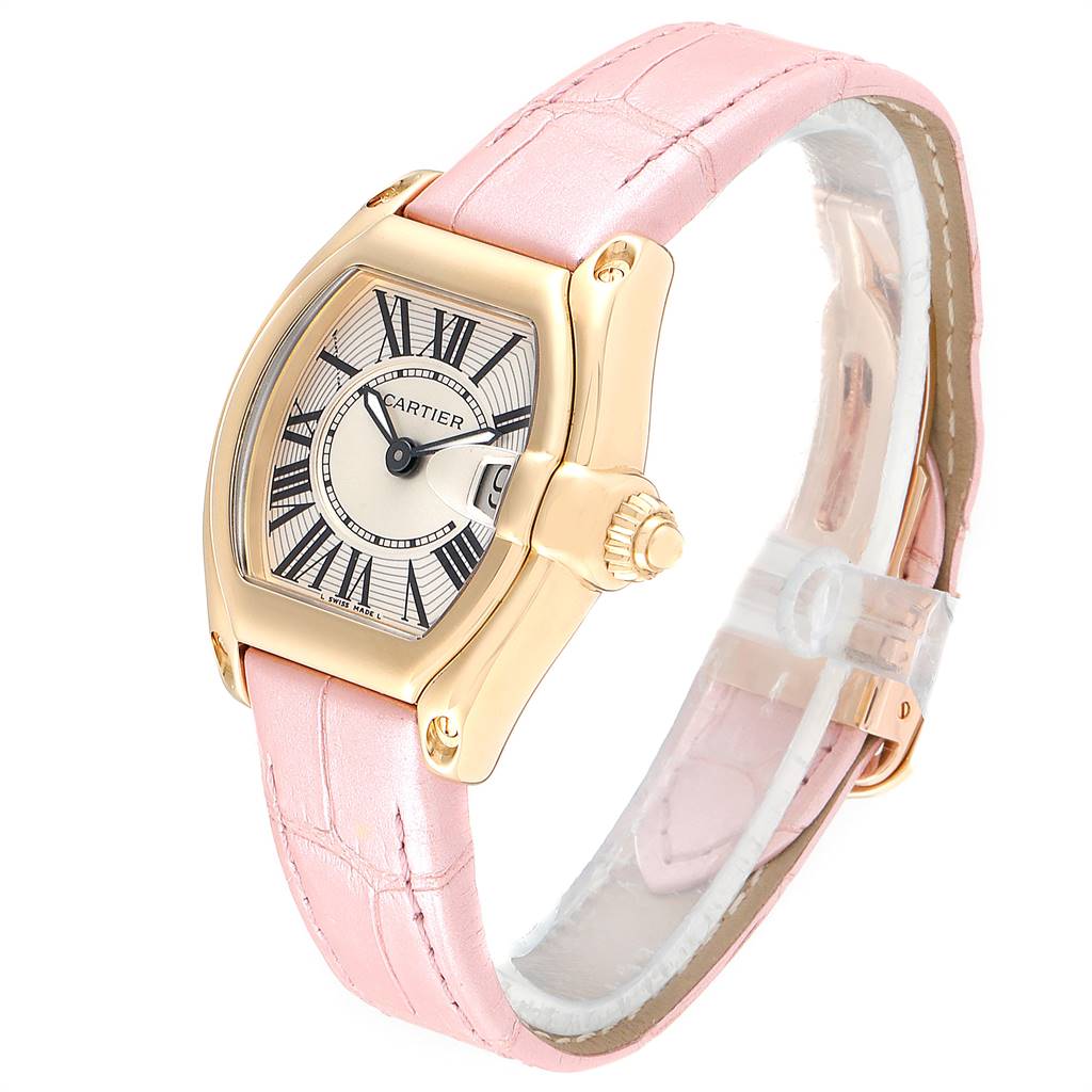 This is a Cartier Roadster W62018Y5 Women
s Yellow Gold Silver Dial W62018Y5 Women
s Yellow Gold Silver Dial watch shown from an angled side view, featuring a pink leather strap and a gold-tone case.