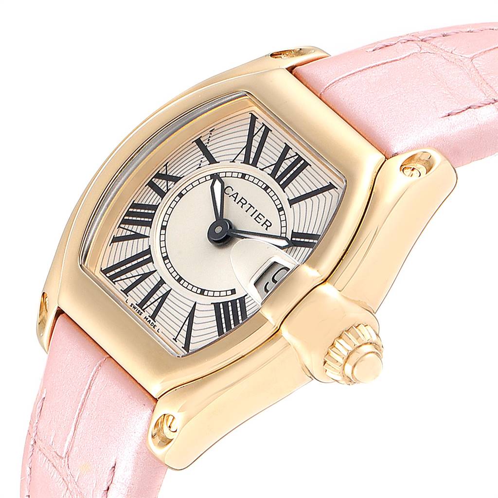 This is a close-up of a Cartier Roadster W62018Y5 Women
s Yellow Gold Silver Dial W62018Y5 Women
s Yellow Gold Silver Dial watch showcasing its dial, case, crown, and pink leather strap from an angled side view.