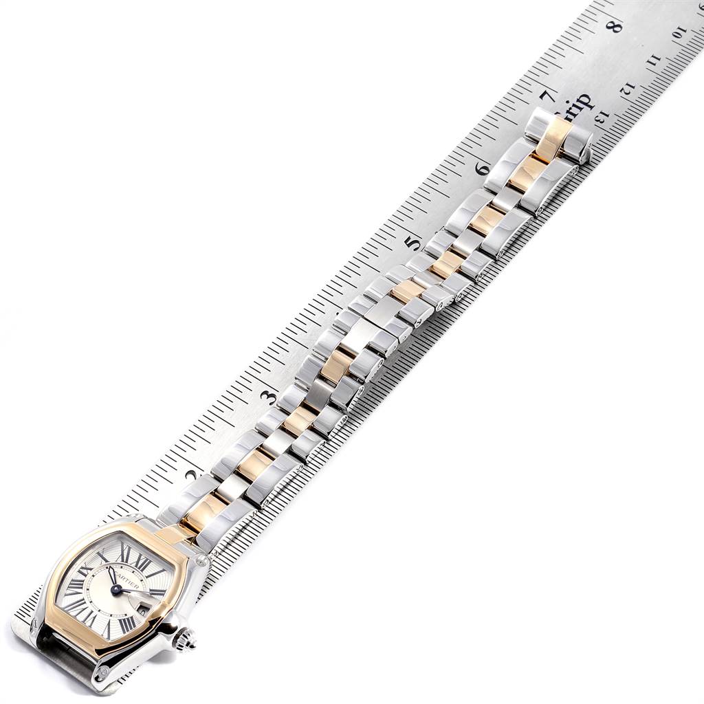 The image shows the Cartier Roadster W62026Y4 Women's Steel and Gold (two tone) Silver Dial W62026Y4 Women's Steel and Gold (two tone) Silver Dial watch laid flat with its bracelet aligned next to a ruler for measurement.