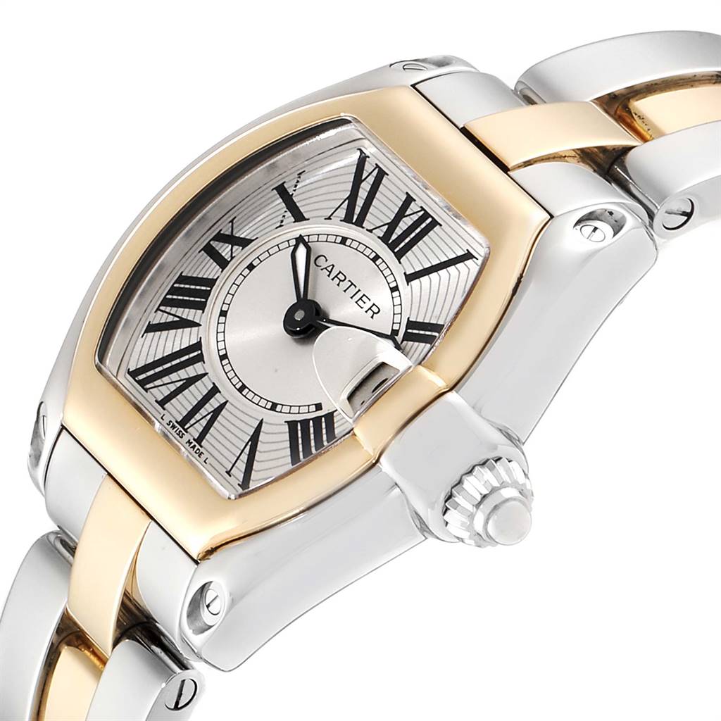 The image shows a close-up of the face and partial bracelet of a Cartier Roadster W62026Y4 Women's Steel and Gold (two tone) Silver Dial W62026Y4 Women's Steel and Gold (two tone) Silver Dial watch, emphasizing its crown and bezel.