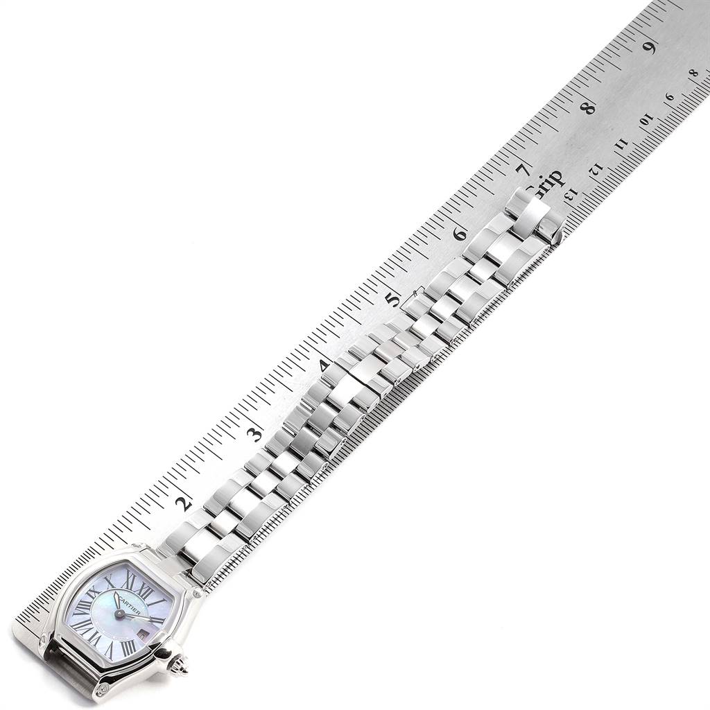 The Cartier Roadster W6206007 Women
s Stainless Steel  W6206007 Women
s Stainless Steel  watch is shown from the left side with its bracelet laid out alongside a ruler.