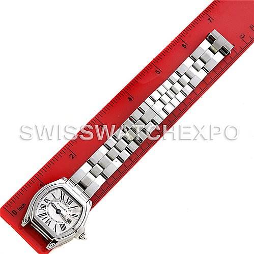 The image shows the Cartier Roadster W62016V3 Women's Stainless Steel Silver Dial W62016V3 Women's Stainless Steel Silver Dial watch laid flat against a red ruler, displaying the face and stainless steel bracelet.