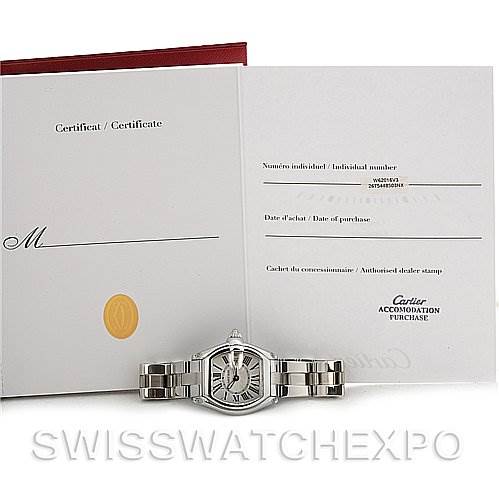 The image shows a Cartier Roadster W62016V3 Women's Stainless Steel Silver Dial W62016V3 Women's Stainless Steel Silver Dial watch and its certificate at a front angle, with the watch partially folded over.