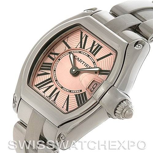 The image shows a Cartier Roadster W62017V3 Women's Stainless Steel Pink Dial W62017V3 Women's Stainless Steel Pink Dial watch at an angled view, highlighting its face, crown, and stainless steel bracelet.