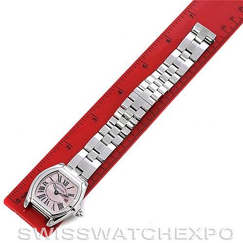 The image shows a Cartier Roadster W62017V3 Women's Stainless Steel Pink Dial W62017V3 Women's Stainless Steel Pink Dial watch laid flat next to a red ruler, highlighting its strap and face from above.