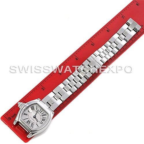 A Cartier Roadster W62016V3 Women
s Stainless Steel Silver Dial W62016V3 Women
s Stainless Steel Silver Dial watch is shown in a top-down angle next to a red ruler.