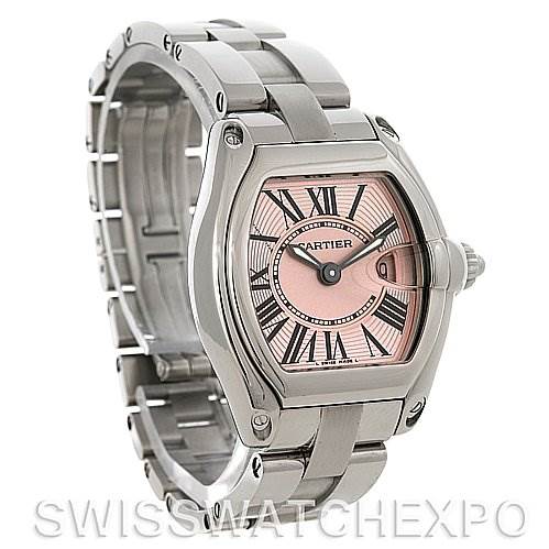 The image shows a Cartier Roadster W62017V3 Women
s Stainless Steel Pink Dial W62017V3 Women
s Stainless Steel Pink Dial watch with a pink dial, viewed from an angled perspective showcasing the face and bracelet.
