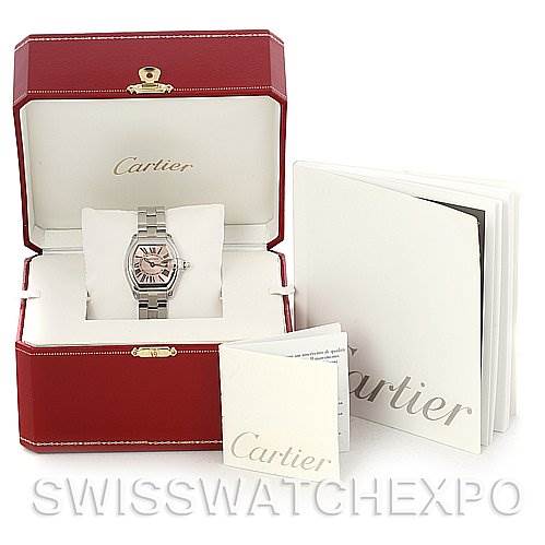 The image shows a Cartier Roadster W62017V3 Women
s Stainless Steel Pink Dial W62017V3 Women
s Stainless Steel Pink Dial watch in an open box, with accompanying booklets displayed beside it.