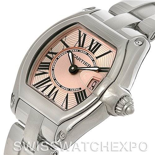 The Cartier Roadster W62017V3 Women
s Stainless Steel Pink Dial W62017V3 Women
s Stainless Steel Pink Dial watch is shown at an angle showcasing the face, crown, and part of the metal bracelet.