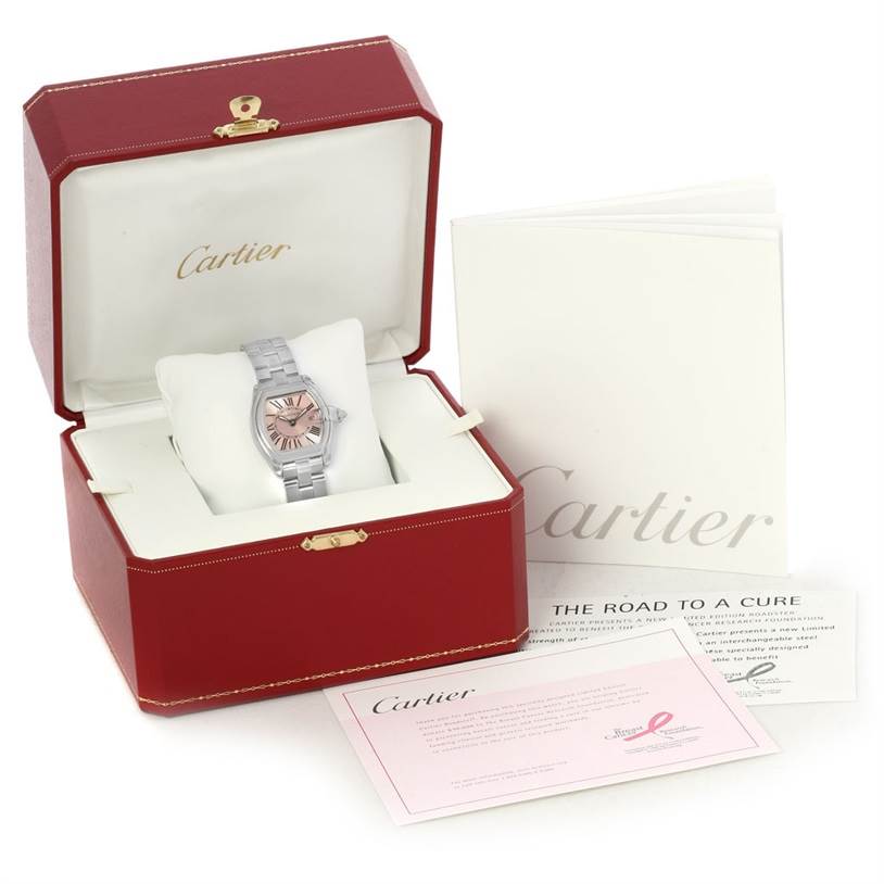 The image shows a Cartier Roadster W62043V3 Women's Stainless Steel Pink Dial W62043V3 Women's Stainless Steel Pink Dial watch in its case, accompanied by booklets and documents.