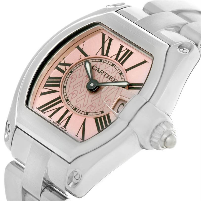 The image shows a close-up angle of the Cartier Roadster W62043V3 Women's Stainless Steel Pink Dial W62043V3 Women's Stainless Steel Pink Dial watch featuring its dial, Roman numerals, and a portion of the metal bracelet.