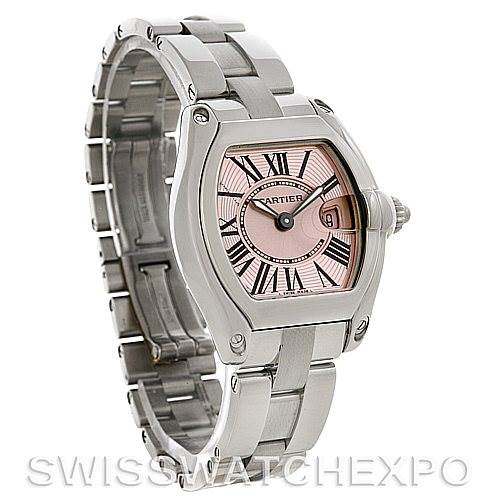 The Cartier Roadster W62017V3 Women
s Stainless Steel Pink Dial W62017V3 Women
s Stainless Steel Pink Dial watch is shown at an angle revealing the face, bezel, crown, and bracelet.