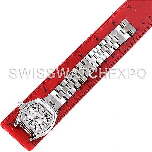 The image shows a Cartier Roadster W62016V3 Women
s Stainless Steel Silver Dial W62016V3 Women
s Stainless Steel Silver Dial watch with a silver bracelet laid flat next to a red ruler for scale.