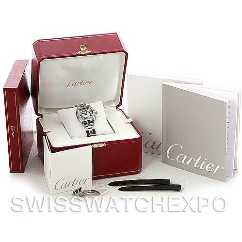 The image shows a Cartier Roadster W62016V3 Women
s Stainless Steel Silver Dial W62016V3 Women
s Stainless Steel Silver Dial watch with its accessories, including a red box, manuals, and tools, viewed from the front.