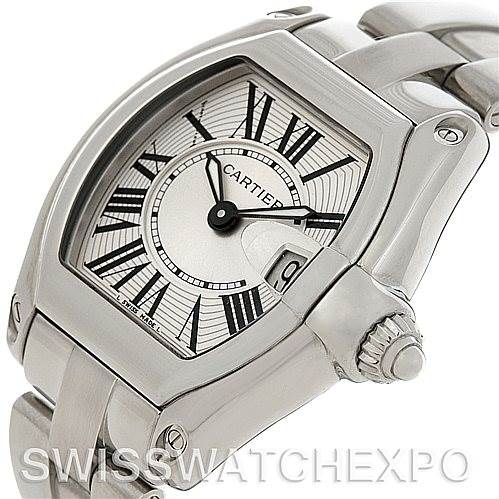 The image shows a close-up side angle of the Cartier Roadster W62016V3 Women
s Stainless Steel Silver Dial W62016V3 Women
s Stainless Steel Silver Dial watch, highlighting the dial, crown, date window, and part of the bracelet.