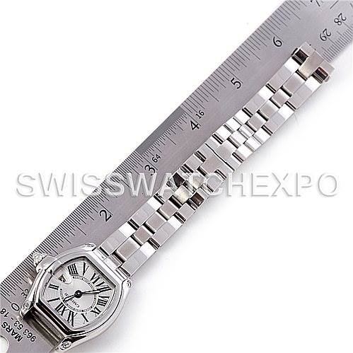 The image shows a top-down view of a Cartier Roadster W62016V3 Women
s Stainless Steel Silver Dial W62016V3 Women
s Stainless Steel Silver Dial watch, displaying the face and the bracelet placed next to a ruler.