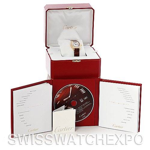 The image shows the Cartier Roadster W62018Y5 Women's Yellow Gold Silver Dial W62018Y5 Women's Yellow Gold Silver Dial watch placed in its open box, along with the instruction manual, a CD, and warranty booklet.
