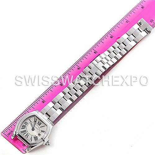 The Cartier Roadster W62016V3 Women
s Stainless Steel Silver Dial W62016V3 Women
s Stainless Steel Silver Dial watch is shown from a top-down angle, displaying the full bracelet and face, next to a pink ruler.