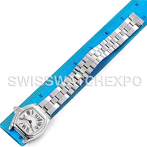 The Cartier Roadster W62016V3 Women
s Stainless Steel Silver Dial W62016V3 Women
s Stainless Steel Silver Dial watch is shown from a top-down angle, displaying its face and full metal bracelet alongside a measuring ruler.