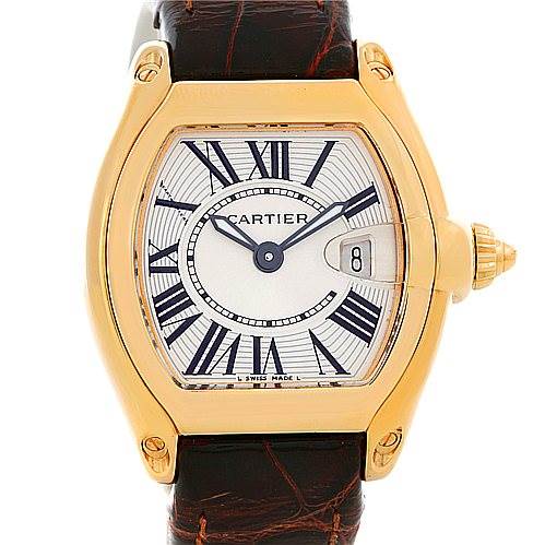 The image shows the face and bezel of a Cartier Roadster W62018Y5 Women's Yellow Gold Silver Dial W62018Y5 Women's Yellow Gold Silver Dial watch, featuring Roman numerals and a brown leather strap.