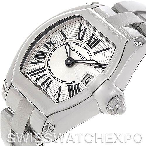 The image shows a close-up angle of the Cartier Roadster W62016V3 Women
s Stainless Steel Silver Dial W62016V3 Women
s Stainless Steel Silver Dial watch, highlighting the dial with Roman numerals, crown, and a part of the bracelet.