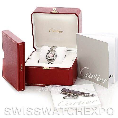 The image shows a Cartier Roadster W62017V3 Women's Stainless Steel Pink Dial W62017V3 Women's Stainless Steel Pink Dial watch with its original red box, booklet, and an extra strap, all from a front angle.