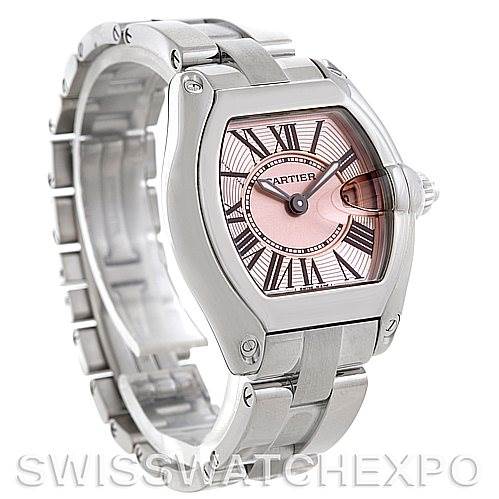 The image features a Cartier Roadster W62017V3 Women's Stainless Steel Pink Dial W62017V3 Women's Stainless Steel Pink Dial watch, showcasing its face, bezel, crown, and bracelet from an angled side view.