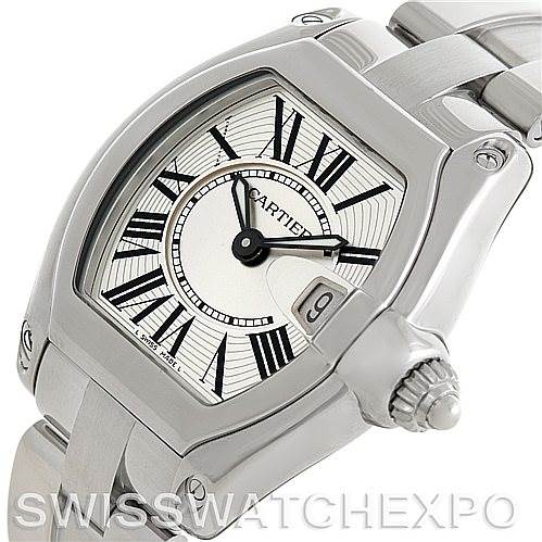 The image shows a close-up of a Cartier Roadster W62016V3 Women's Stainless Steel Silver Dial W62016V3 Women's Stainless Steel Silver Dial watch, highlighting the face, crown, and part of the bracelet.