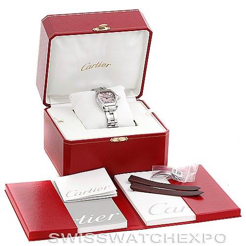 The image shows a Cartier Roadster W62017V3 Women's Stainless Steel Pink Dial W62017V3 Women's Stainless Steel Pink Dial watch in its presentation box, along with additional straps, booklets, and tags displayed outside the box.