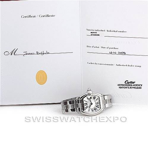 The image shows a Cartier Roadster W62016V3 Women's Stainless Steel Silver Dial W62016V3 Women's Stainless Steel Silver Dial watch placed next to its certificate of authenticity and warranty card.