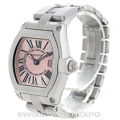 This image showcases a Cartier Roadster W62017V3 Women's Stainless Steel Pink Dial W62017V3 Women's Stainless Steel Pink Dial watch at a three-quarter angle, highlighting the pink dial, Roman numerals, and metal bracelet.