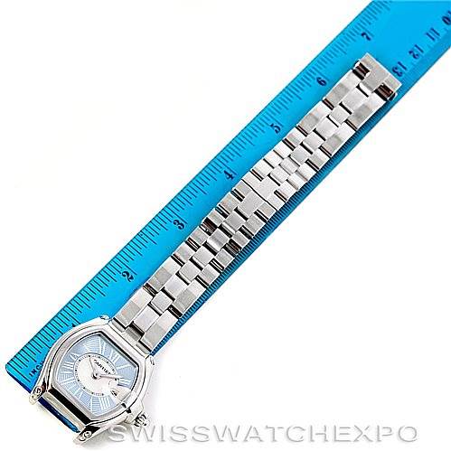 The image shows a Cartier Roadster W62053V3 Women's Stainless Steel Blue Dial W62053V3 Women's Stainless Steel Blue Dial watch laid flat next to a blue ruler, highlighting both the face and metal bracelet.