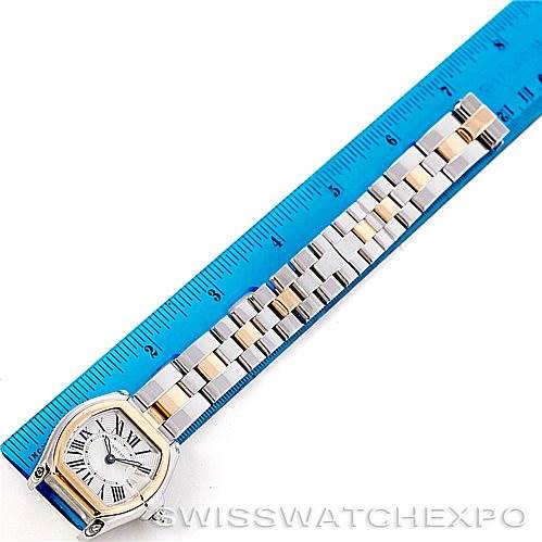 The image shows a Cartier Roadster W62026Y4 Women's Steel and Gold (two tone) Silver Dial W62026Y4 Women's Steel and Gold (two tone) Silver Dial watch laid flat next to a blue ruler, showcasing its stainless steel and gold bracelet and face.