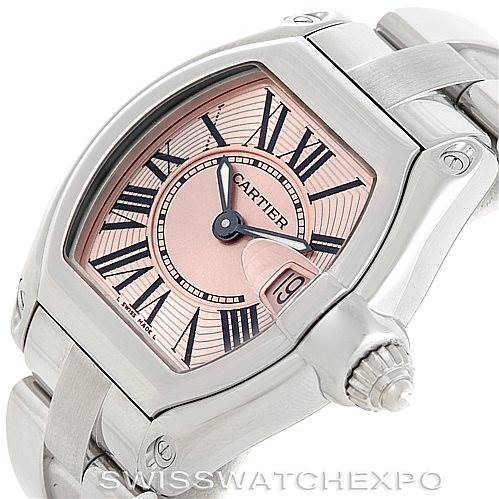 This image shows a Cartier Roadster W62017V3 Women's Stainless Steel Pink Dial W62017V3 Women's Stainless Steel Pink Dial watch from a three-quarter angle, highlighting the dial, crown, and part of the bracelet.