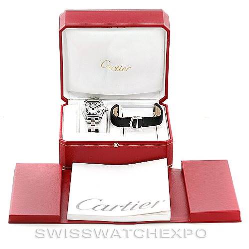 The image shows a Cartier Roadster W62016V3 Women's Stainless Steel Silver Dial W62016V3 Women's Stainless Steel Silver Dial model watch in its case with an additional strap and Cartier-branded documentation at a front-facing angle.