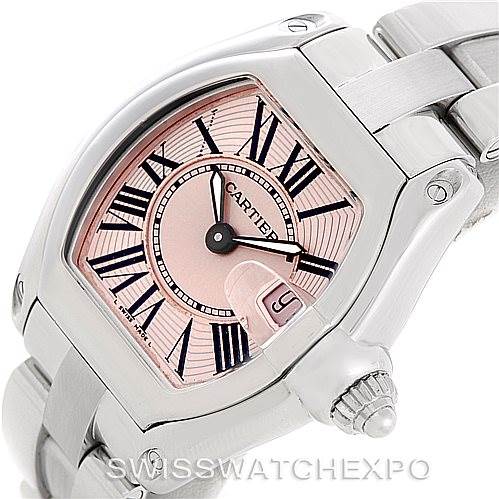 The image shows a close-up view of a Cartier Roadster W62017V3 Women's Stainless Steel Pink Dial W62017V3 Women's Stainless Steel Pink Dial watch, highlighting the face, crown, and part of the metal bracelet.