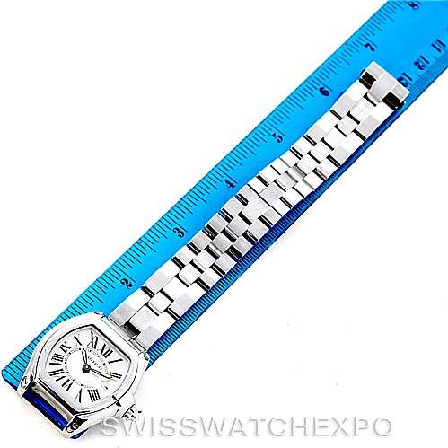 The image shows a Cartier Roadster W62016V3 Women's Stainless Steel Silver Dial W62016V3 Women's Stainless Steel Silver Dial watch laid flat with its face and full metal bracelet visible next to a blue ruler for scale.