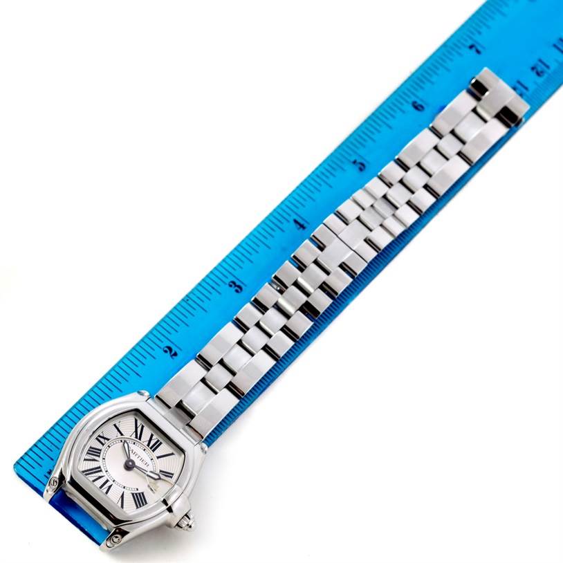 The Cartier Roadster W62016V3 Women's Stainless Steel Silver Dial W62016V3 Women's Stainless Steel Silver Dial watch is shown laid flat, face-up, alongside a ruler.