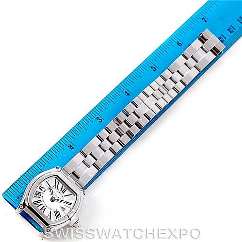 The Cartier Roadster W62016V3 Women's Stainless Steel Silver Dial W62016V3 Women's Stainless Steel Silver Dial watch is shown from an overhead angle, displaying the face, bezel, and full bracelet alongside a blue ruler.