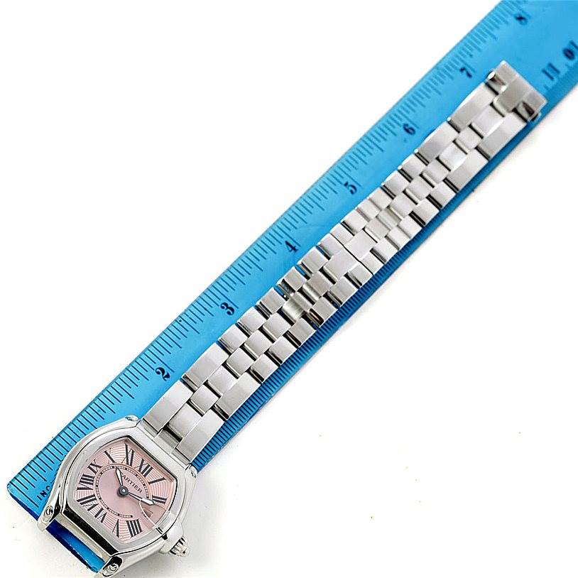This image shows a Cartier Roadster W62017V3 Women's Stainless Steel Pink Dial W62017V3 Women's Stainless Steel Pink Dial watch laid flat with its face, bezel, and bracelet visible, measured against a blue ruler.