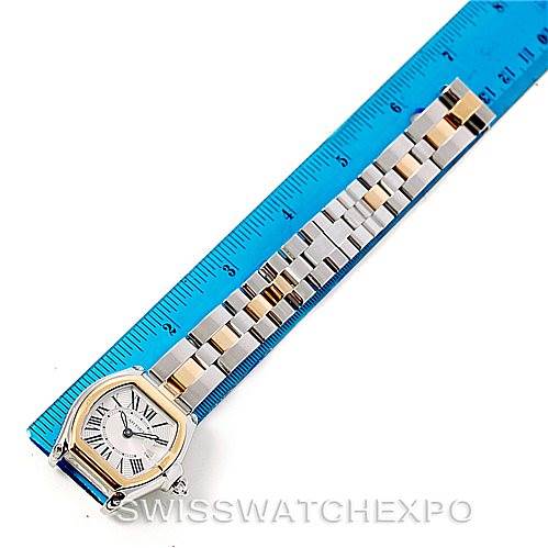 The image shows a Cartier Roadster W62026Y4 Women's Steel and Gold (two tone) Silver Dial W62026Y4 Women's Steel and Gold (two tone) Silver Dial watch laid flat next to a blue ruler, highlighting both the watch face and the full bracelet.