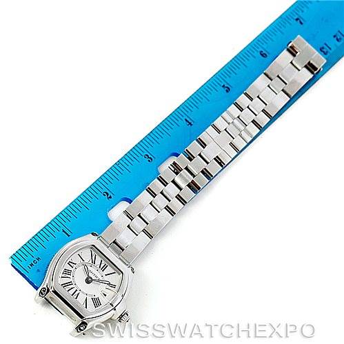 The image shows the top view of a Cartier Roadster W62016V3 Women's Stainless Steel Silver Dial W62016V3 Women's Stainless Steel Silver Dial watch, highlighting the face and full metal bracelet next to a blue ruler.