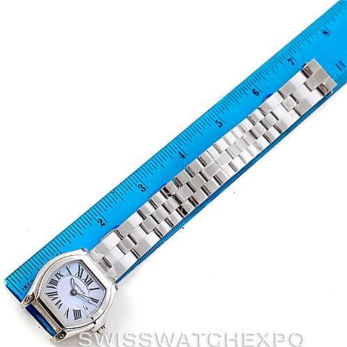 The Cartier Roadster W6206007 Women's Stainless Steel Mother of Pearl Dial W6206007 Women's Stainless Steel Mother of Pearl Dial watch is shown from a top-down angle, with its face, bezel, and metal strap aligned with a blue ruler for measurement.