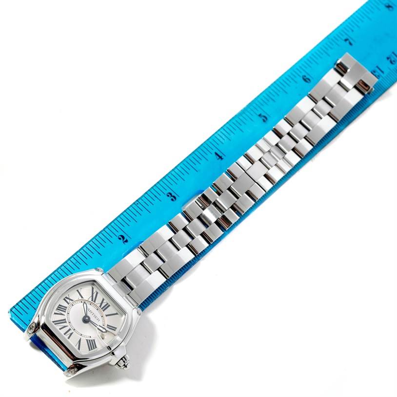 The image shows a Cartier Roadster W62016V3 Women's Stainless Steel Silver Dial W62016V3 Women's Stainless Steel Silver Dial watch laid flat next to a blue ruler, displaying its face and full bracelet.