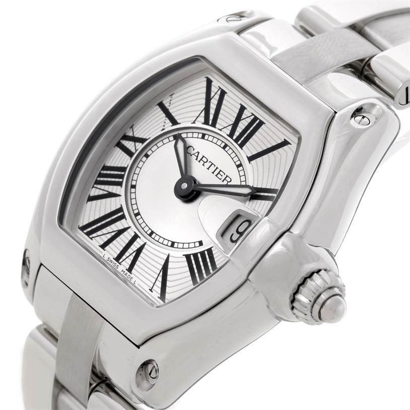 The image shows a close-up of the Cartier Roadster W62016V3 Women's Stainless Steel Silver Dial W62016V3 Women's Stainless Steel Silver Dial watch face and part of its stainless steel bracelet from an angled view.