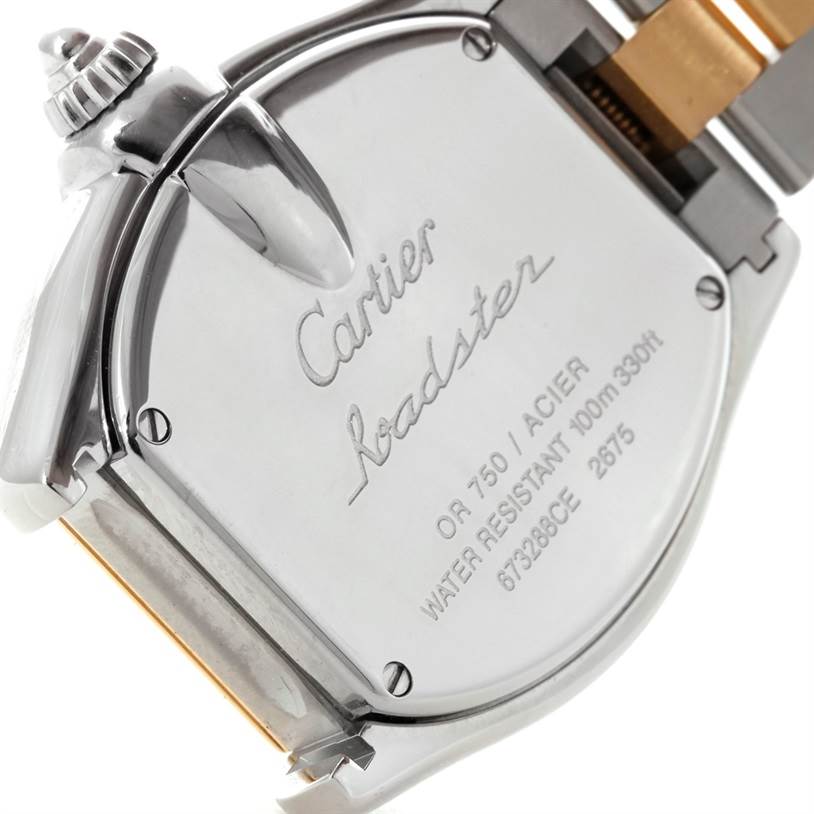 The image shows the back case of a Cartier Roadster W62026Y4 Women's Steel and Gold (two tone) Silver Dial W62026Y4 Women's Steel and Gold (two tone) Silver Dial watch at an angled view, highlighting the engraved details.