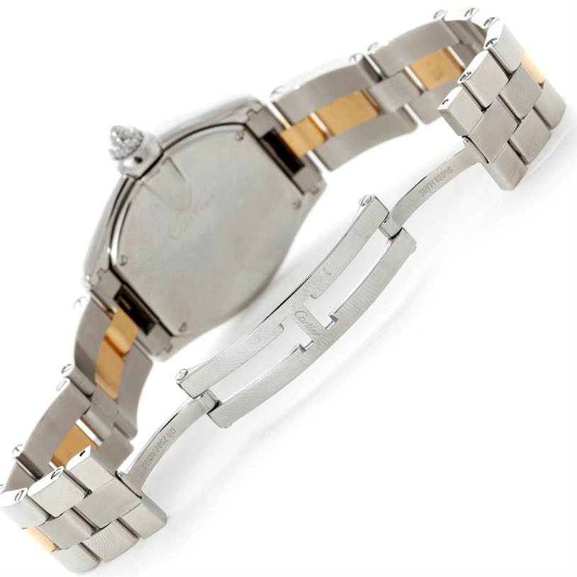 This image shows the back case, crown, and partially opened clasp of the Roadster model by Cartier.
