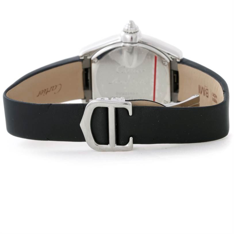 The image shows the back view of a Cartier Roadster W62026Y4 Women's Steel and Gold (two tone) Silver Dial W62026Y4 Women's Steel and Gold (two tone) Silver Dial watch, focusing on the case back and the black strap with a metal buckle.